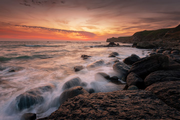 Seascape during sunrise. Beautiful natural seascape. Sea sunrise at the Black Sea coast. Magnificent sunrise with clouds and fire sun at the beginning of April.