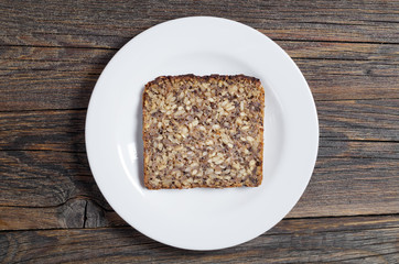 Slice of bread with seeds in a plate
