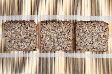 Three slices of bread with different seeds