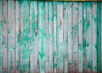 The old wooden walls painted green. Old wooden wall background or texture.