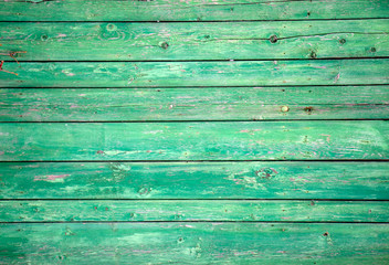 The old wooden walls painted green. Old wooden wall background or texture.