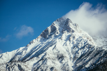 Fototapeta na wymiar Epic snowy mountain peak with clouds in winter, landscape, alps, austria