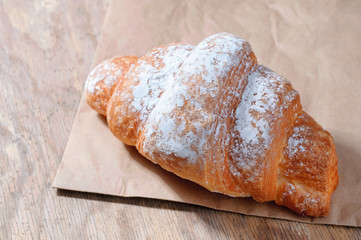Top view of Baked Tasty croissants on old wooden surface