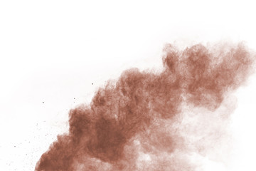 Brown color powder explosion on white background. Colored cloud. Colorful dust explode. Paint Holi.