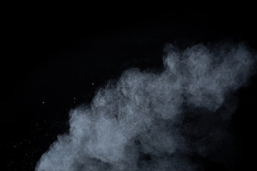 White powder explosion on black background. Colored cloud. Colorful dust explode. Paint Holi.