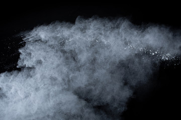 Obraz na płótnie Canvas White powder explosion on black background. Colored cloud. Colorful dust explode. Paint Holi.