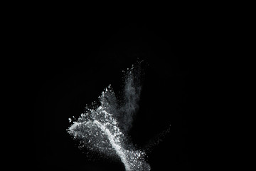 White powder explosion on black background. Colored cloud. Colorful dust explode. Paint Holi.