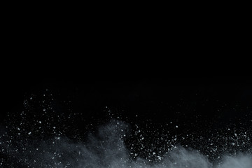 White powder explosion on black background. Colored cloud. Colorful dust explode. Paint Holi.