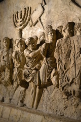 Wall relief on arch of titus depicting Menorah taken from temple in Jerusalem in 70 AD - Israel history, Jewish war