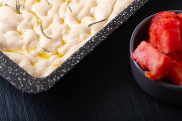 Food concept homemade organic focaccia dough in iron pan with copy space