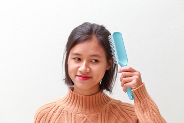 young woman using a hair brush