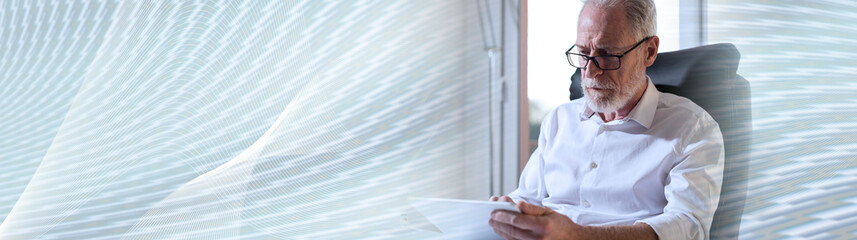 Fototapeta premium Senior businessman using a digital tablet. panoramic banner
