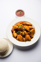 Masala fried Idlies or Idli fry - south indian Snack made using with leftover idly served with tomato ketchup. selective focus