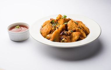 Masala fried Idlies or Idli fry - south indian Snack made using with leftover idly served with tomato ketchup. selective focus
