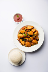 Masala fried Idlies or Idli fry - south indian Snack made using with leftover idly served with tomato ketchup. selective focus