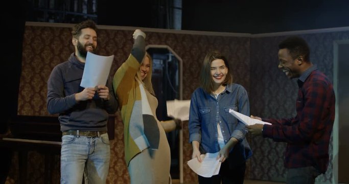 Medium shot of actors and actresses arguing during rehearsal in a theater