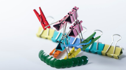Man, from multi-colored office clips for paper on white background