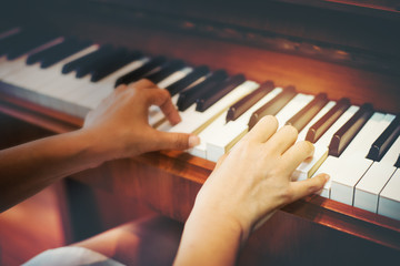 Fototapeta premium Close up hand play piano,studenten practise music or play to show in party.