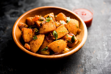 Masala fried Idlies or Idli fry - south indian Snack made using with leftover idly served with tomato ketchup. selective focus