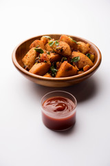 Masala fried Idlies or Idli fry - south indian Snack made using with leftover idly served with tomato ketchup. selective focus