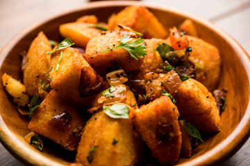 Masala fried Idlies or Idli fry - south indian Snack made using with leftover idly served with tomato ketchup. selective focus