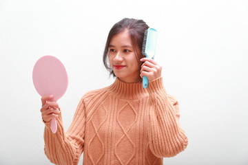 young woman using a hand mirror