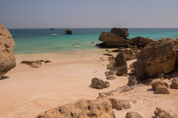 Fototapeta na wymiar A beach with large boulders by the Arabian Sea. Oman