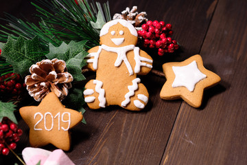 ginger biscuit and marshmallow on brown background with Christmas tree ,  candles and christmas lights. Copy space