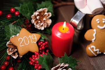  ginger biscuit on brown background with Christmas tree ,  candles and christmas lights. 