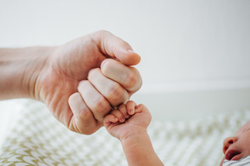father fist bumping child