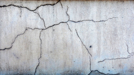 Close-up photo. Fragment of masonry wall cracked decorative plaster.
