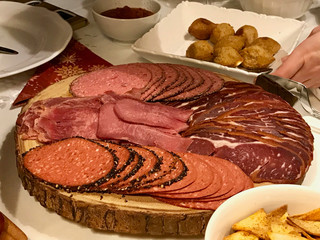 Antipasto delicatessen - sliced meat, ham, salami, pastrami / pastirma and beef tongue slices on wooden board.