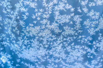 Snowflakes pattern on glass frosted textured background winter