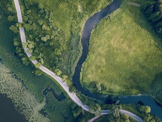 Aerial Photo of Road going by the River under the Trees, Top Down View in Early Spring on Sunny Day