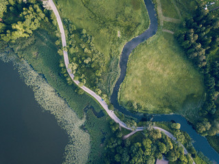 Aerial Photo of Road going by the River under the Trees, Top Down View in Early Spring on Sunny Day