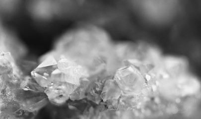 Black and white photograph of the structure of the surface of crystals. Close-up. Blurred background.