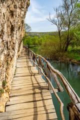 Wooden boardwalk along Zlatna Panega karst River at Iskar-Panega Eco-path Geopark, the first geopark in Bulgaria