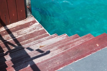 Red wooden steps in Male harbor (Maldives, Asia)