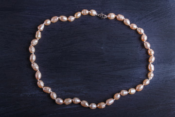 caramel colored pearl beads on a black background