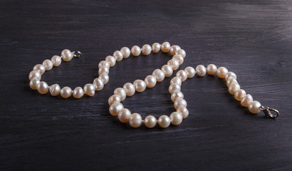 caramel colored pearl beads on a black background