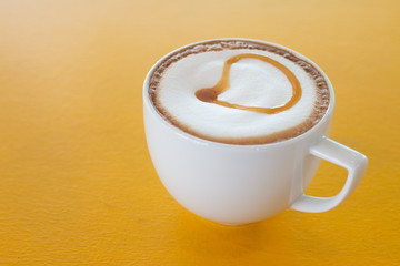 A cup of Piccolo Latte  on wooden desk, Relaxing time or coffee's break time during work day
