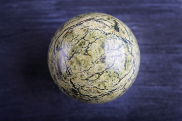 green serpentine sphere on a black background