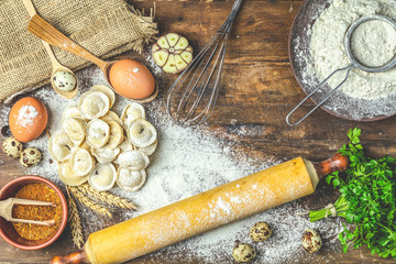 Italian ravioli, dumplings with meat on dark wooden old surface