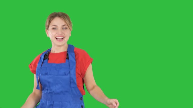 Woman in construction helmet dancing on a Green Screen, Chroma Key.