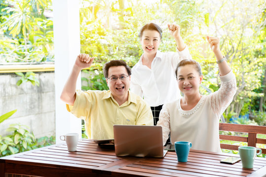 Group Asian elderly men and women are living the tablet and laptop happily with a smile of friendship. By searching for health care information tourism And investment after retirement. Elderly concept