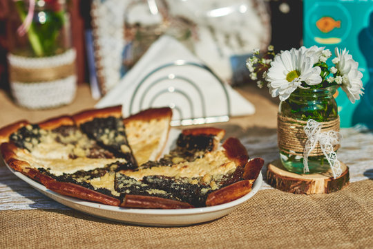 Delicious baked wedding cake and pastry set up on the rustic wooden table