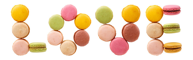 Word LOVE from multi-colored macaroon cookies. Flat lay, top view, isolated on white.