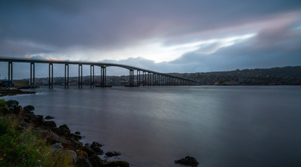 View of Tromso Bridge across Tromsoysundet strait in Norway at dusk. It connects Tromso on island of Tromsoya with Tromsdalen on mainland