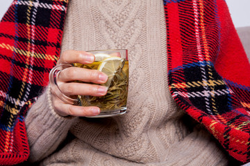  Warm cup of hot  sage warming in the hands of a woman.