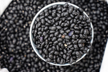 Black bean in bowl on wooden background
